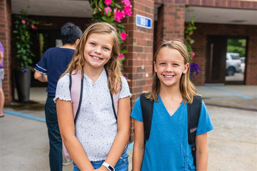 Two students smile